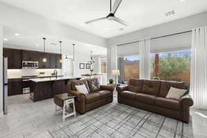 Living area featuring a ceiling fan, a chandelier, and recessed lighting