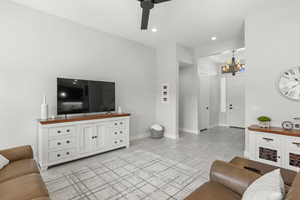 Living room featuring recessed lighting, a chandelier, and ceiling fan