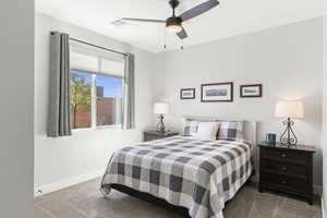 Carpeted bedroom with baseboards and a ceiling fan