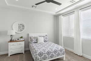 Bedroom featuring a tray ceiling, light carpet, recessed lighting, and ceiling fan