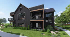 Rear view of house with a metal roof, a balcony, a lawn, and a patio area