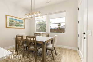 Dining space featuring light wood-type flooring and baseboards