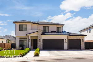 View of front of house featuring stone siding, driveway, and stucco siding