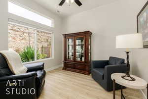 Living area featuring light wood-style floors and ceiling fan