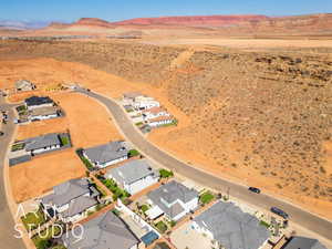 Aerial view of residential area featuring a mountainous background and a desert landscape