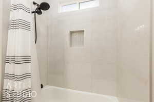 Full bathroom with shower / bath combination with curtain