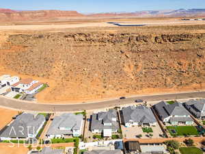 Aerial view of residential area with a mountainous background and a desert landscape