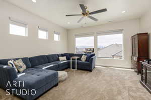 Living area featuring light carpet, healthy amount of natural light, recessed lighting, and ceiling fan