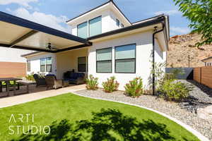 Rear view of house with an outdoor hangout area, a ceiling fan, stucco siding, and a patio area