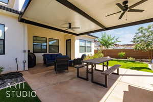 Fenced backyard with ceiling fan, an outdoor living space, and a patio