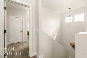 Stairs featuring carpet flooring and baseboards