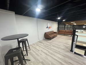 Living room with light wood-type flooring and baseboards