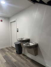 Bathroom featuring dark wood-style floors and baseboards