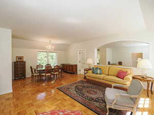 Living area with a chandelier and lofted ceiling