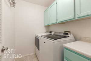 Laundry area with independent washer and dryer and cabinet space