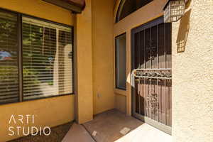 Entrance to property with stucco siding
