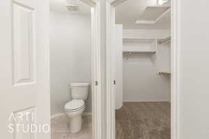 Bathroom with a textured ceiling and a spacious closet