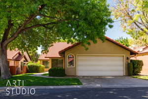 Mediterranean / spanish-style house featuring a tiled roof, stucco siding, concrete driveway, and a garage