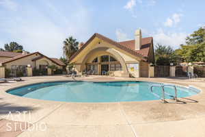 Community pool with a patio