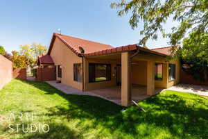 Rear view of house with a patio, stucco siding, and a tile roof