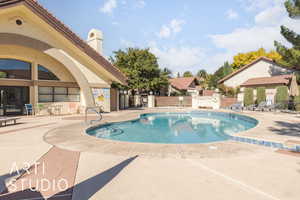 Community pool with a patio
