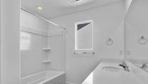 Full bath featuring bathtub / shower combination, vanity, and recessed lighting