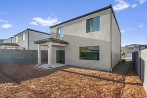 Back of property featuring a patio, a fenced backyard, and stucco siding