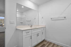 Full bath with vanity, a shower, dark wood-type flooring, and recessed lighting
