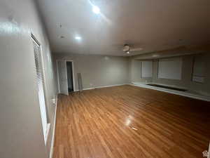 Unfurnished living room featuring light wood-type flooring and ceiling fan