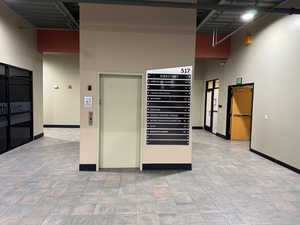 Interior space featuring elevator and a high ceiling