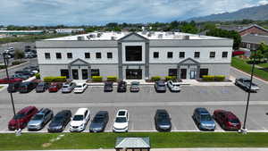 View of building exterior with uncovered parking and a mountain view