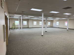 Basement with carpet flooring and a paneled ceiling
