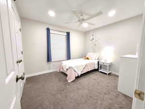 Carpeted bedroom featuring a ceiling fan, recessed lighting, and a closet