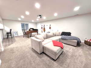 Living room featuring light colored carpet and recessed lighting