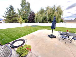 Fenced backyard with new landscaped yard, new patio and outdoor dining area