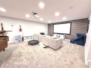 Cinema featuring light colored carpet, recessed lighting, and wood walls