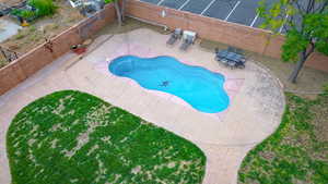 View of pool featuring a fenced backyard, outdoor dining space, and a patio