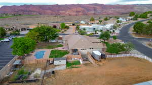 Aerial perspective of suburban area featuring a mountain backdrop and a pool