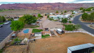 Aerial perspective of suburban area featuring a mountainous background and a pool area