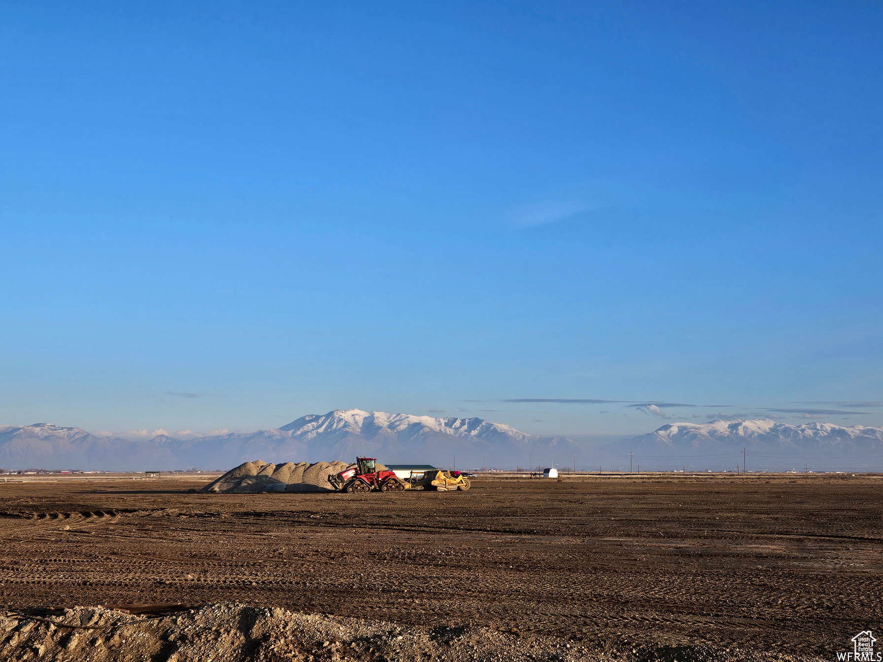 View of mountain backdrop with rural landscape