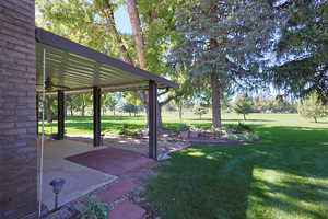 View of grassy yard with a patio