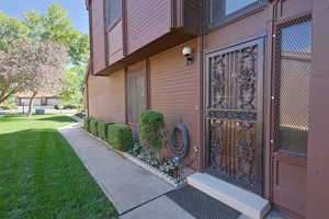 Entrance to property with a lawn