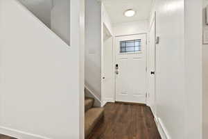 Doorway featuring wood finished floors and stairs
