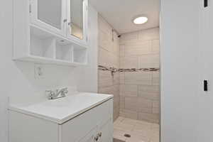 Bathroom featuring a stall shower and vanity
