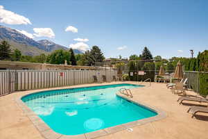 Community pool featuring a patio and a mountain view