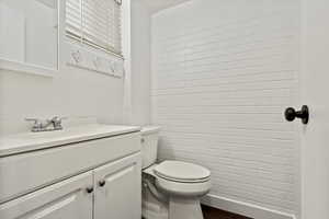 Bathroom featuring vanity and dark wood-style flooring