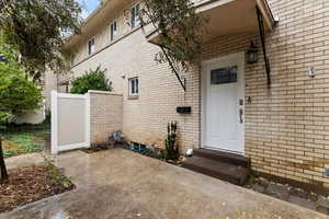 View of exterior entry with brick siding
