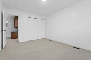 Unfurnished bedroom with carpet floors and a closet