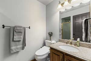 Bathroom featuring vanity and a shower stall