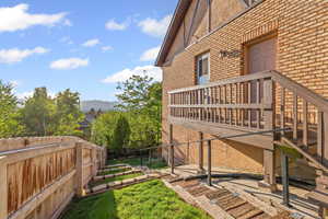 Fenced backyard featuring a mountain view and stairway